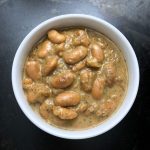 Emergo white beans in a bowl on a table.