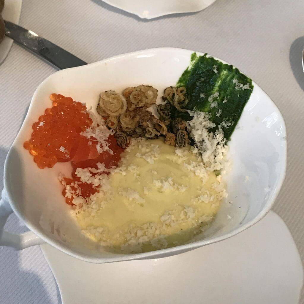 A white bowl of food on a table.