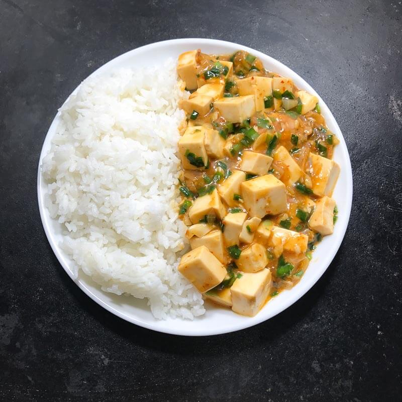 Meatless Mapo Tofu with Nira and rice on a plate