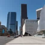 A city street with tall buildings in the background.