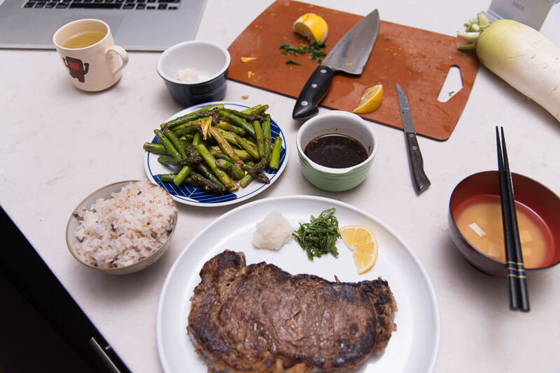 steak on a plate with sidedish of rice and vegetables