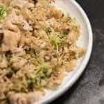 A plate of chicken fried rice on a table.