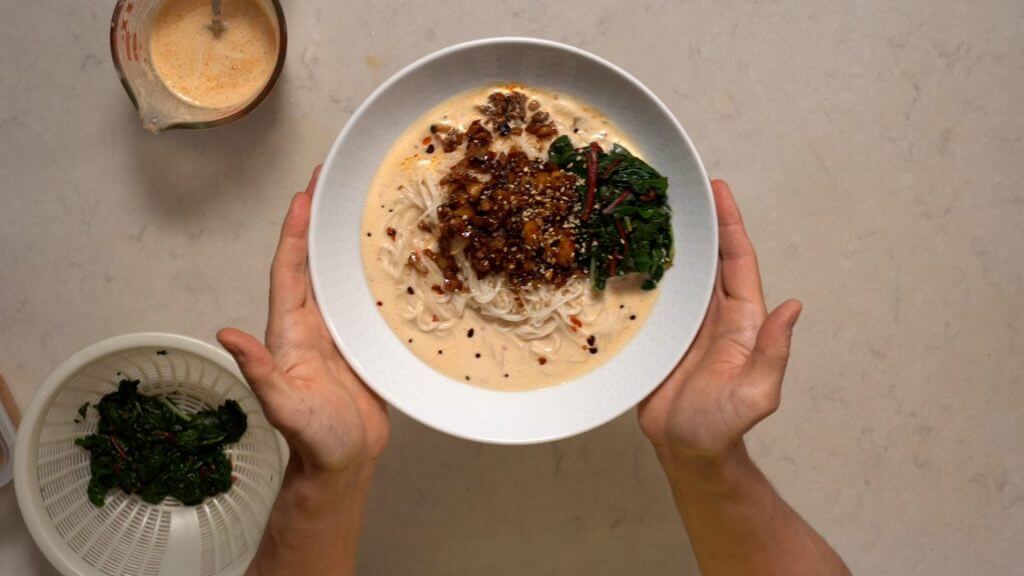 hold a plated tantanmen ramen bowl