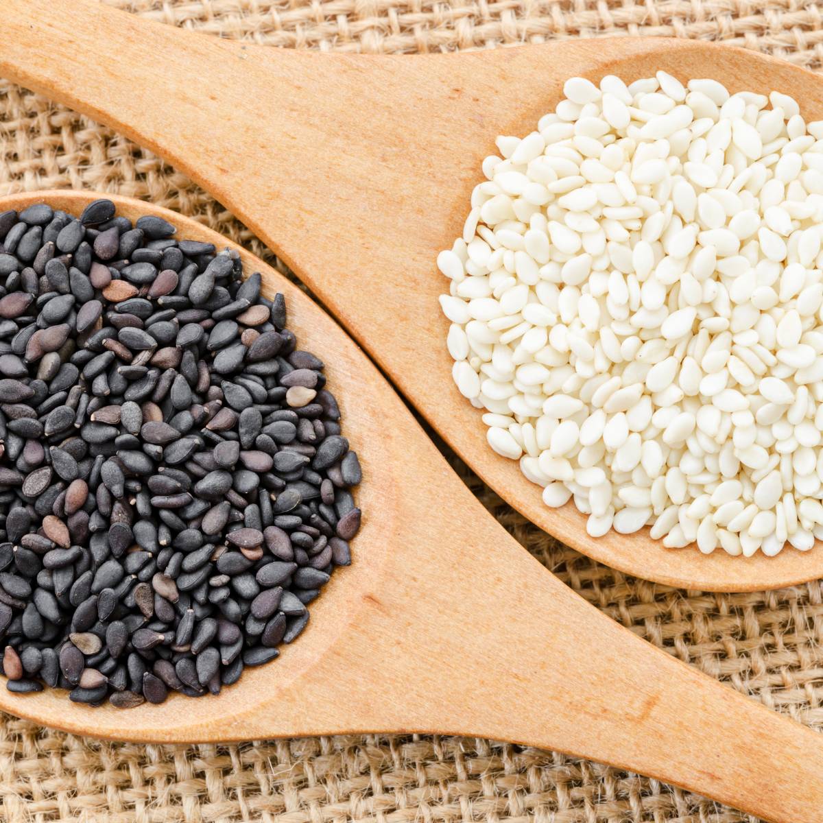 black sesame and white sesame on a wooden spoon