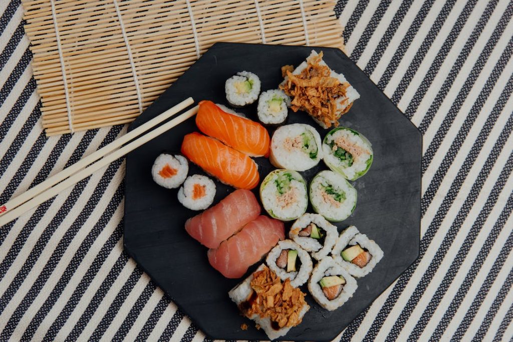 Japanese sushi on a black plate.