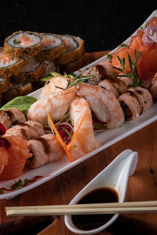 Japanese sushi on a plate with chopsticks.