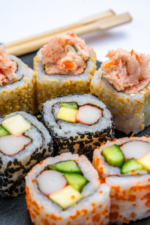 Plated Japanese sushi served with chopsticks, bursting with exquisite taste.