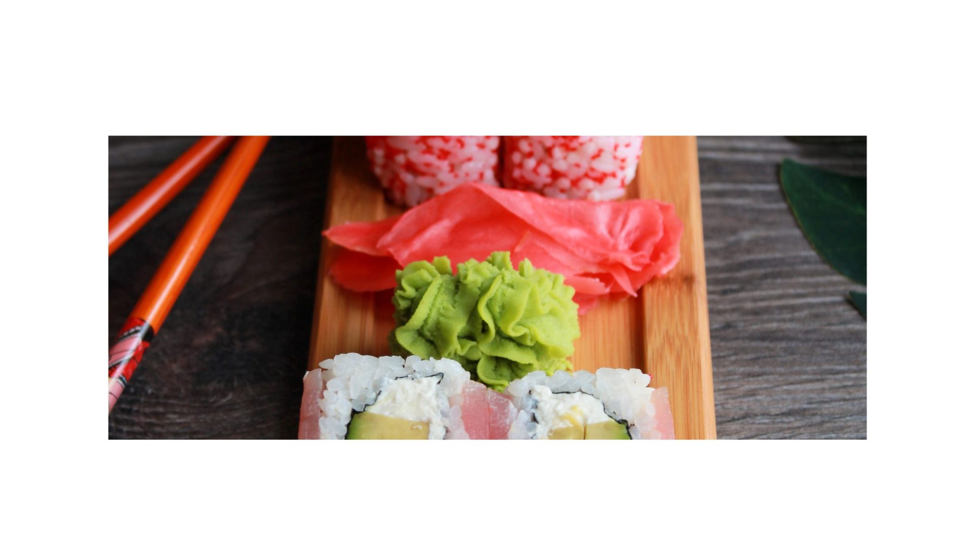 Toro sushi on a wooden tray with chopsticks.