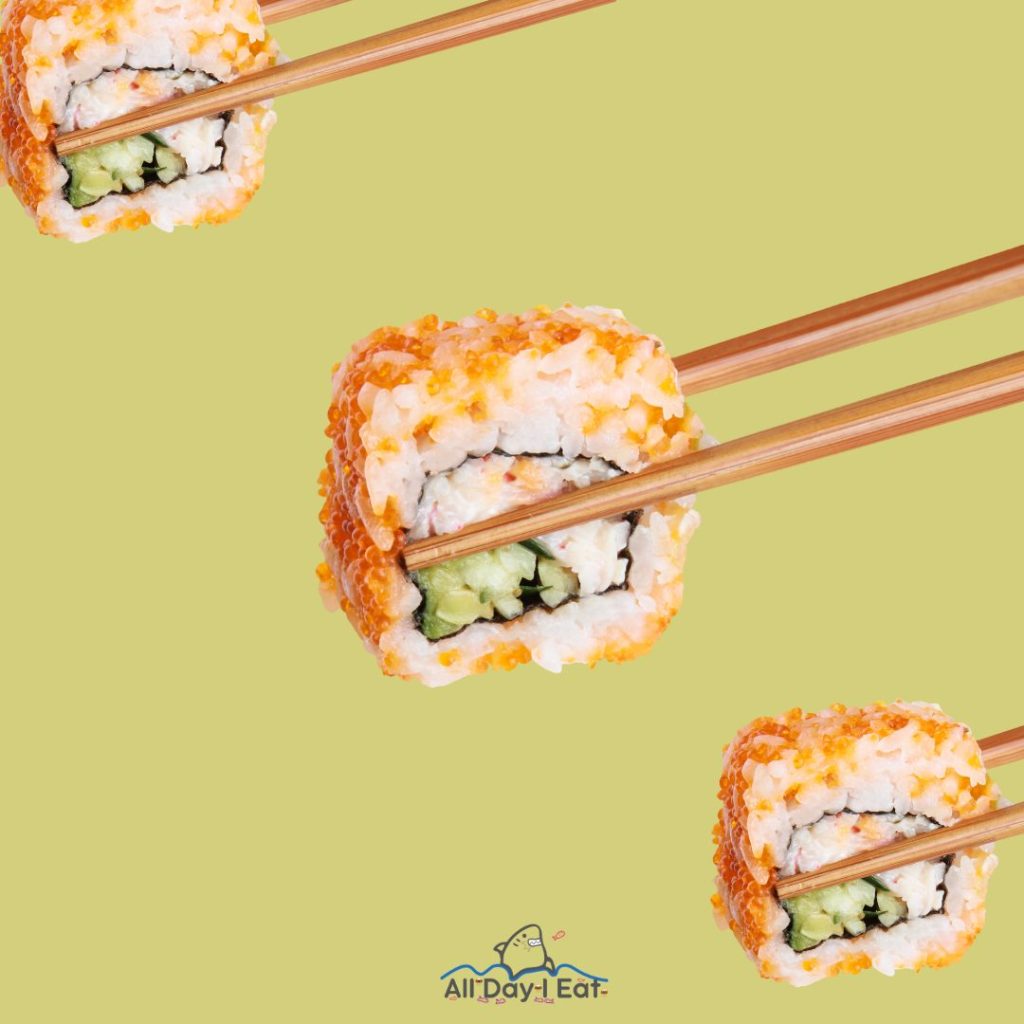 Three sushi rolls with chopsticks on a yellow background, showcasing the art of sushi.