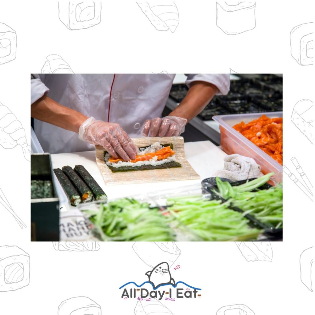 A chef is cooking sushi rice in a kitchen.