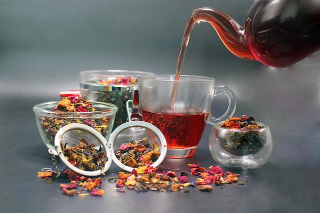 tea being poured with metal filter in the front