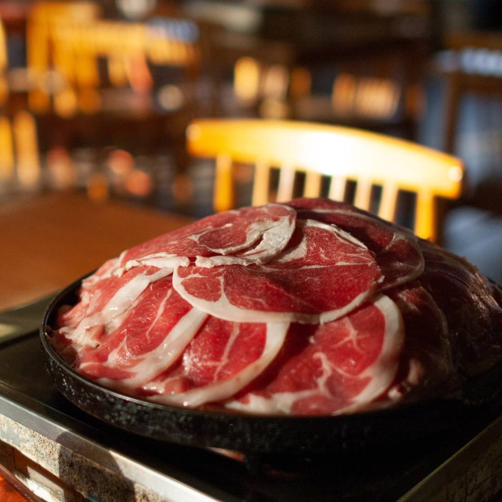 A Hokkaido-inspired plate of meat on a table.