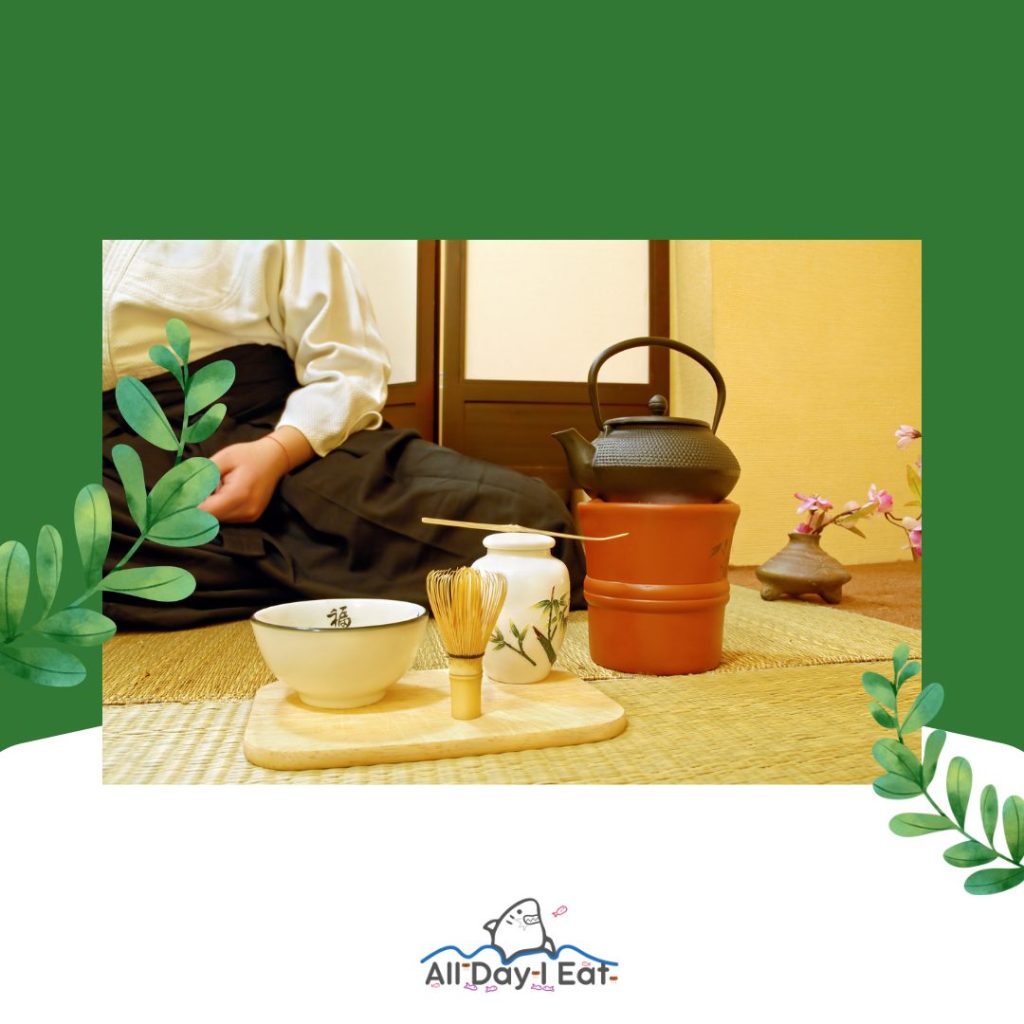 A man enjoying a cup of tea at night on a mat with a teapot.