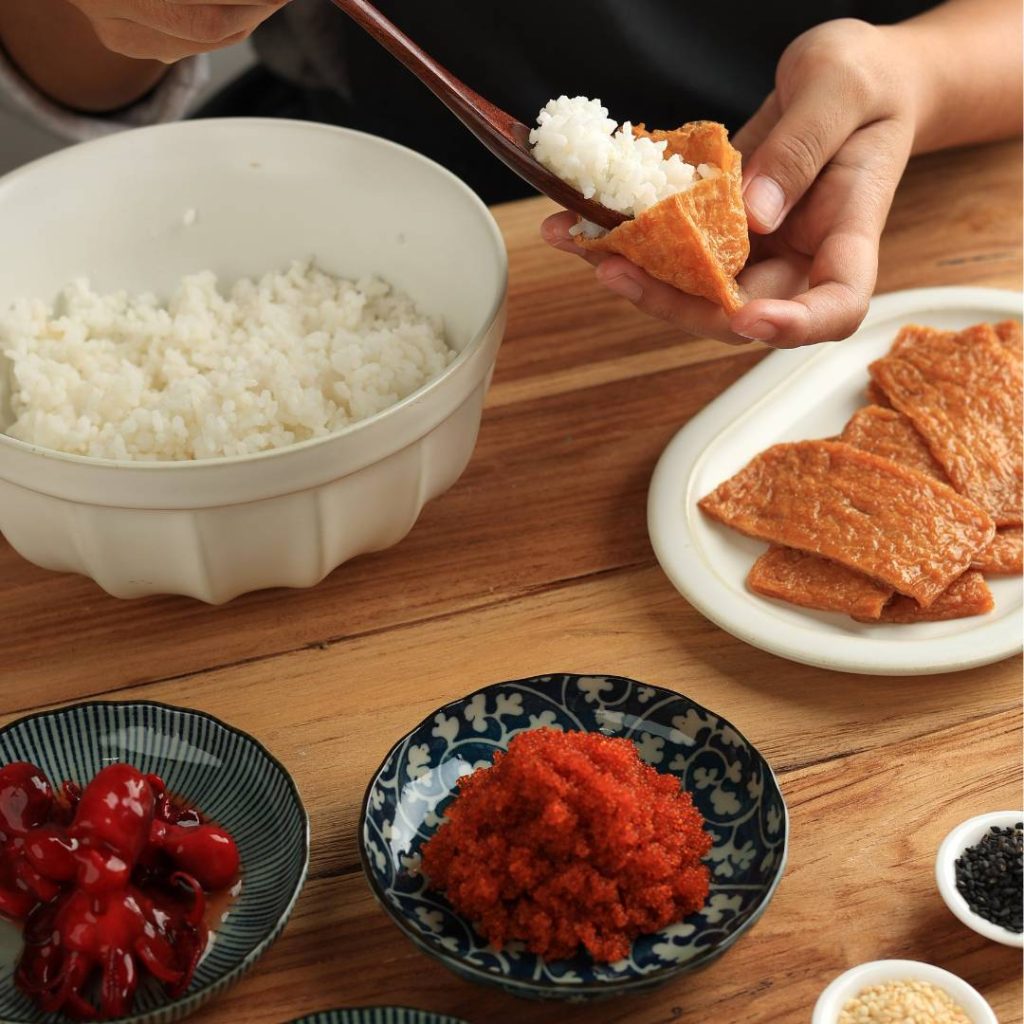 A person is preparing inari sushi.