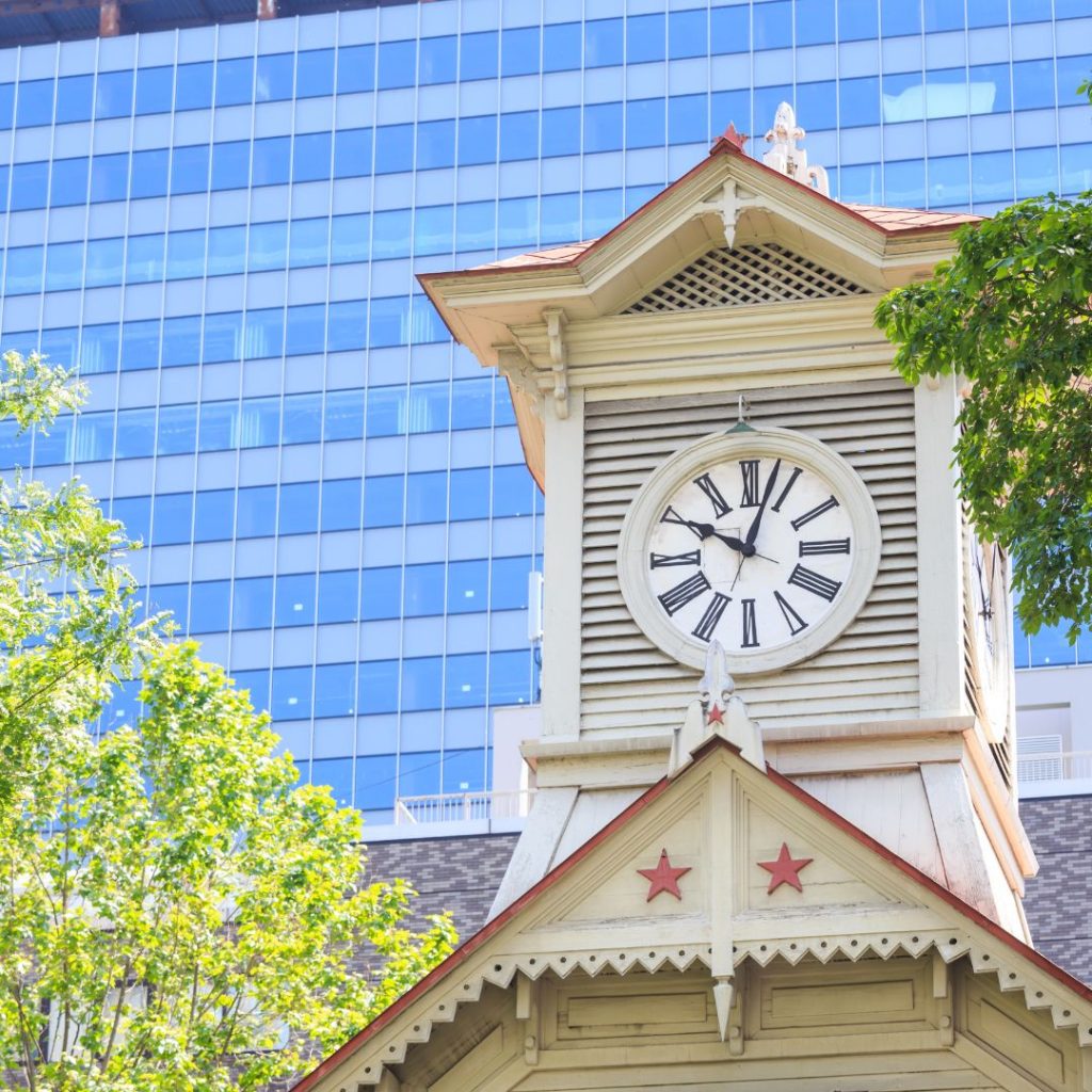 A Hokkaido clock tower in front of a building.