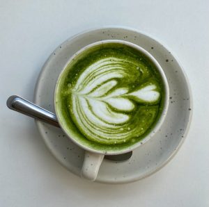 A matcha latte served on a plate.