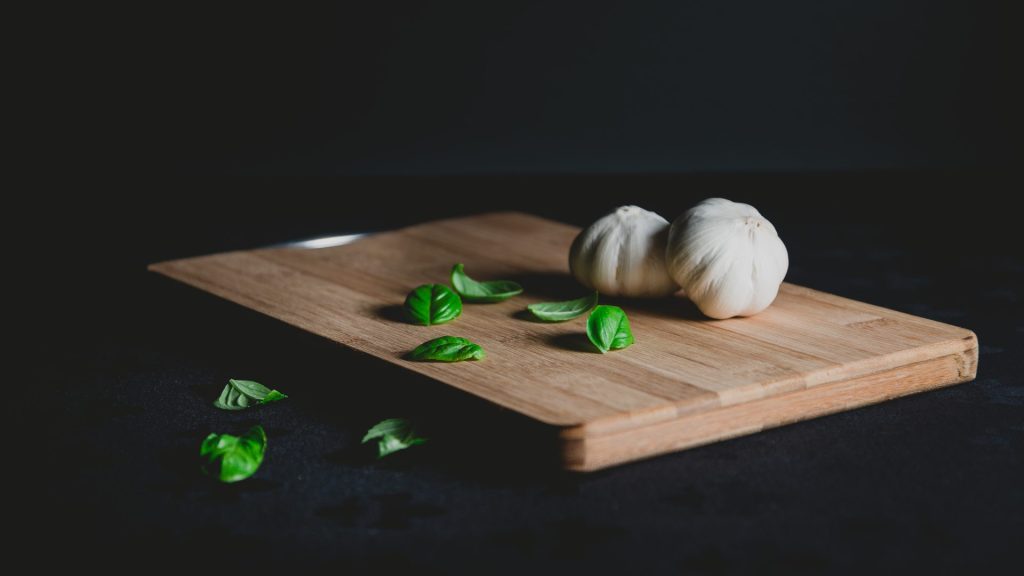 An image that showcases a beautifully oiled Hinoki cutting board, with the natural grain enhanced, reflecting a warm and inviting ambiance