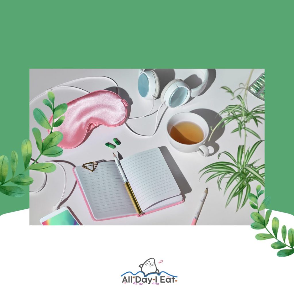 A plant on a green background with a notebook and headphones, perfect for tea at night.