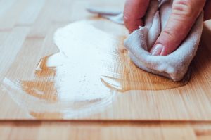 A person oiling the cutting board