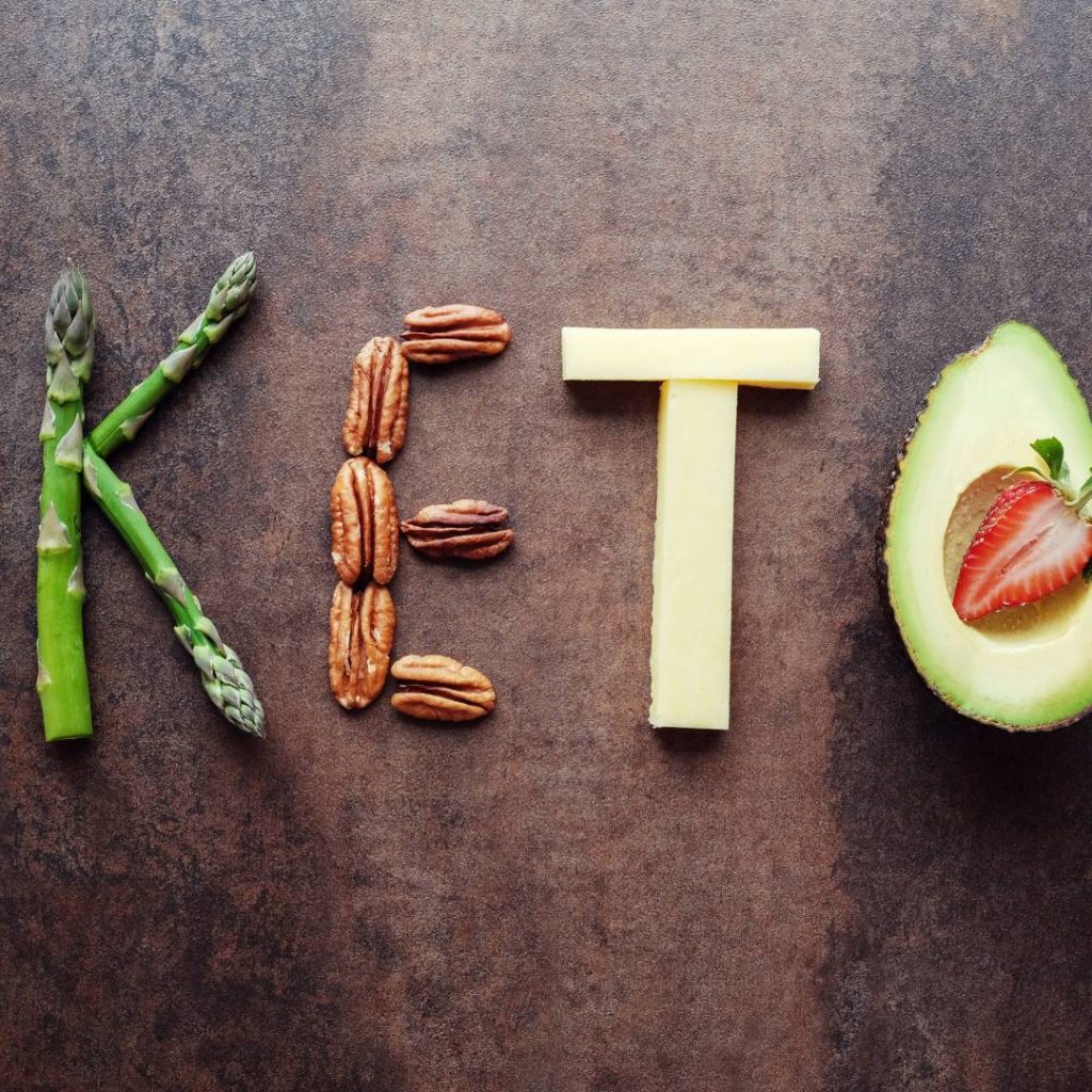 Illustrative image of keto spelled with avocado, pecans, and strawberries.