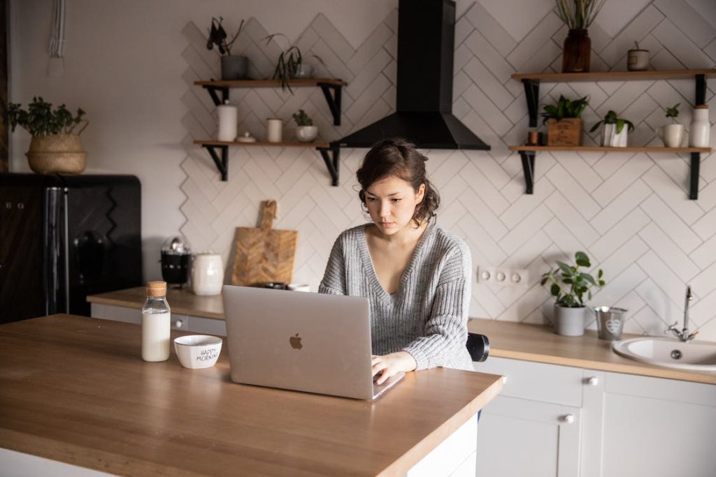 lady using a laptop in the kitchen