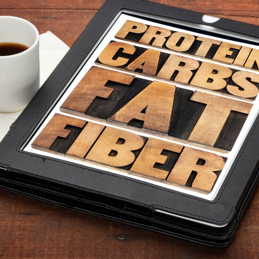 A tablet displaying protein, carbs, fat, and fiber information with a focus on sushi's carb content.