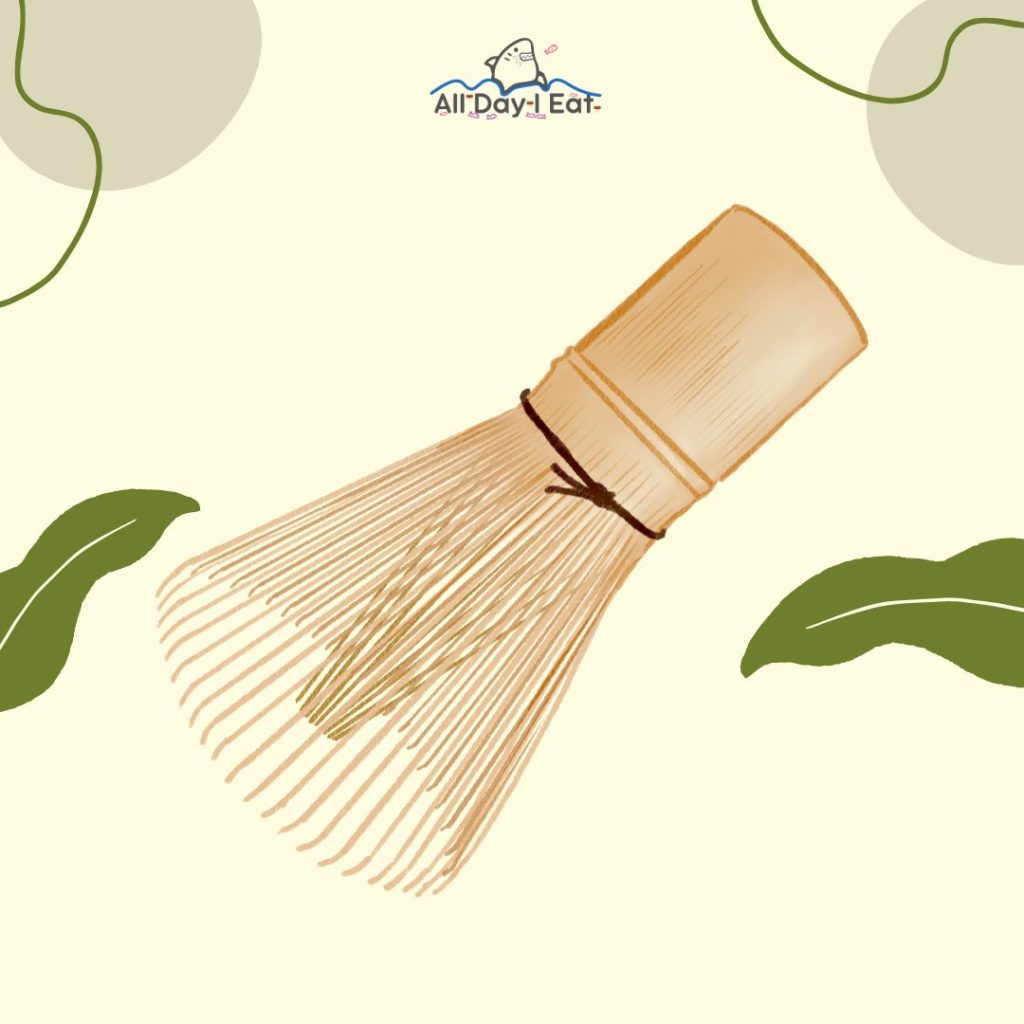 An illustration of a matcha whisk with green leaves.