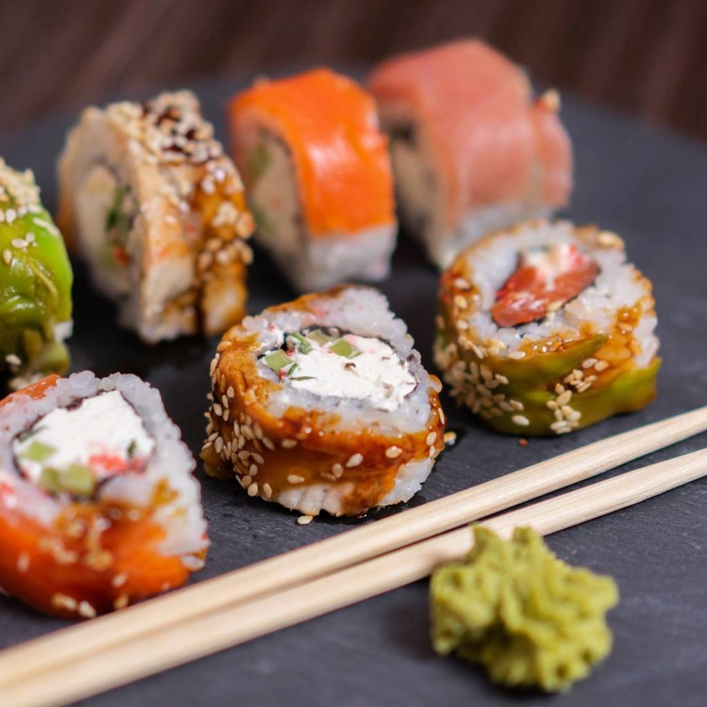 Japanese sushi with sushi rice on a black plate.