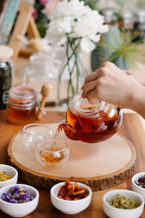 tea being poured from a glass tea pot