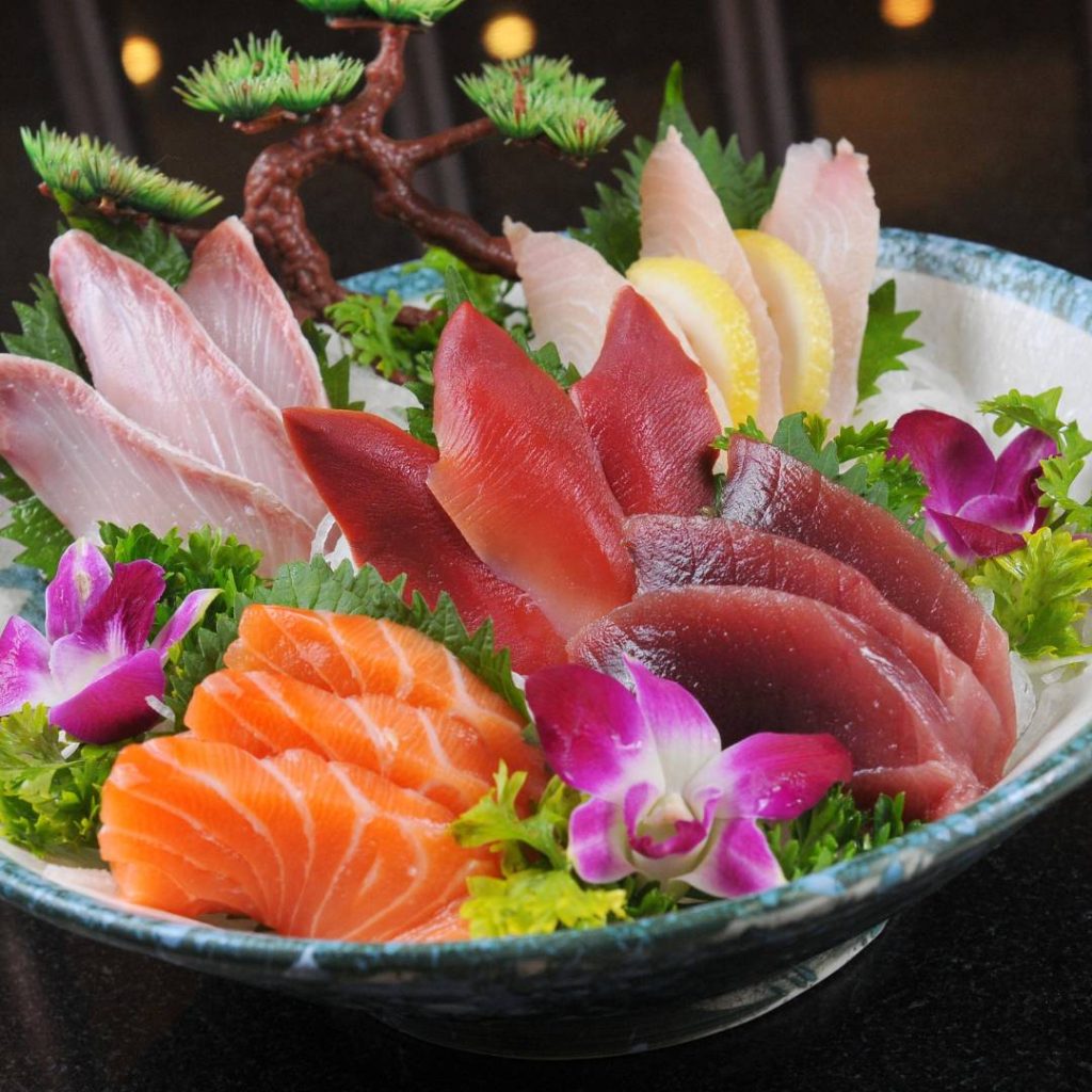 Japanese sashimi in a bowl on a table.