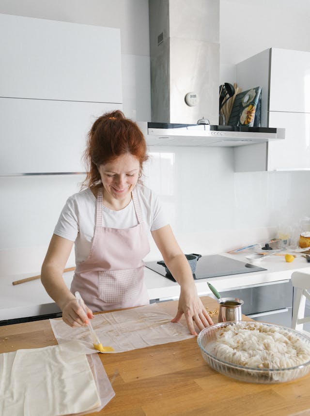 woman brushing a parchment paper