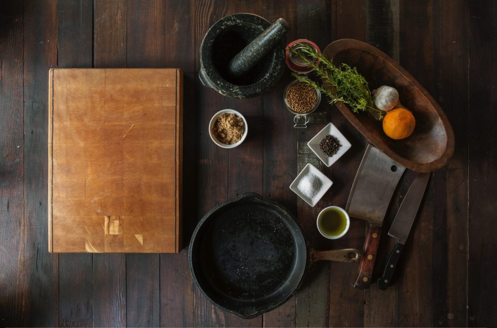 An image showcasing a wooden cutting board with deep, weathered grooves from years of use, juxtaposed with a pristine plastic cutting board, displaying not a single scratch, highlighting the topic of Durability and Longevity