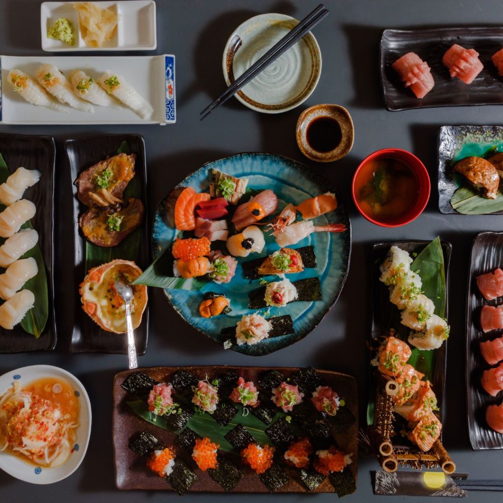 A set of Japanese dishes rest on a table together.