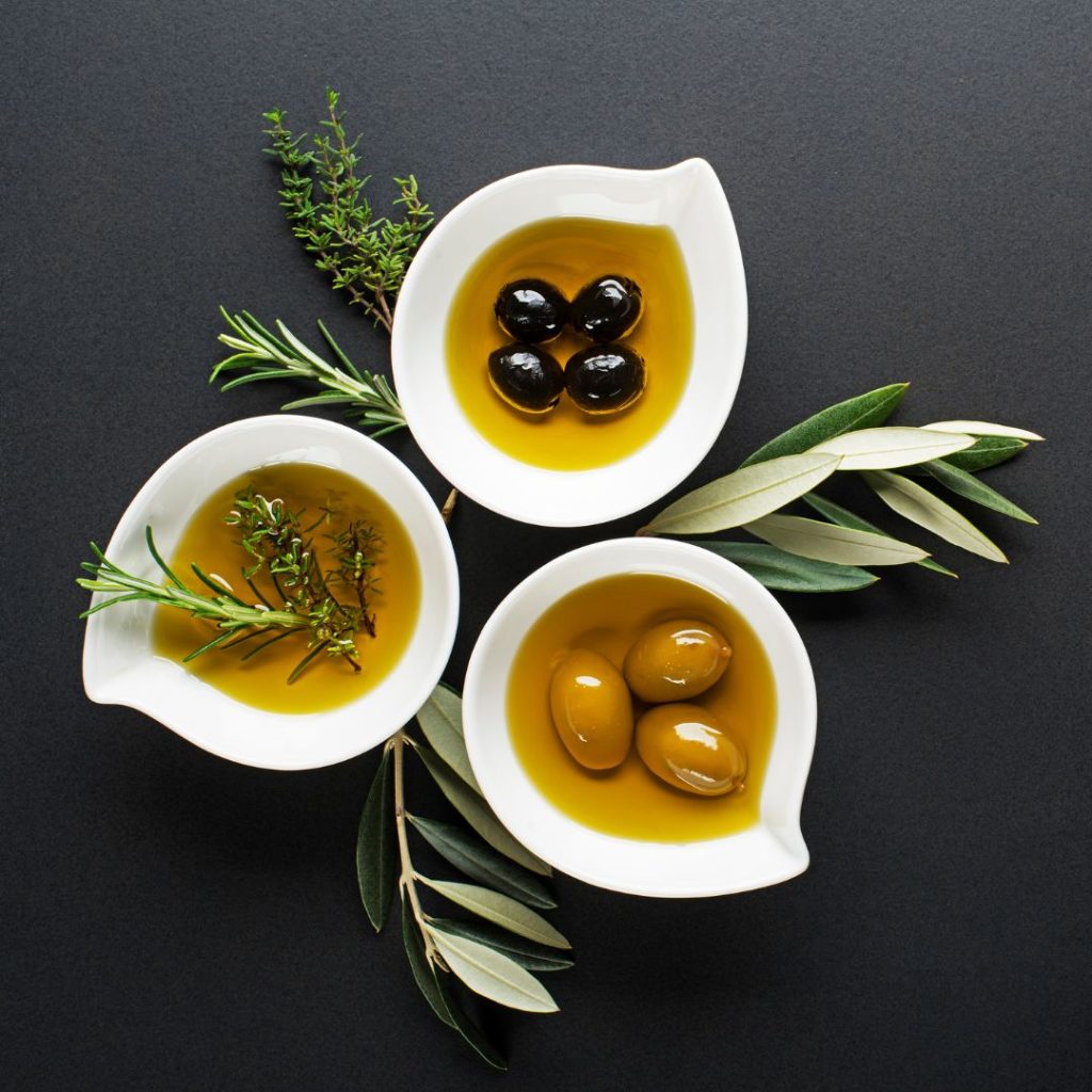 A variety of olive oils lay flat on the table.