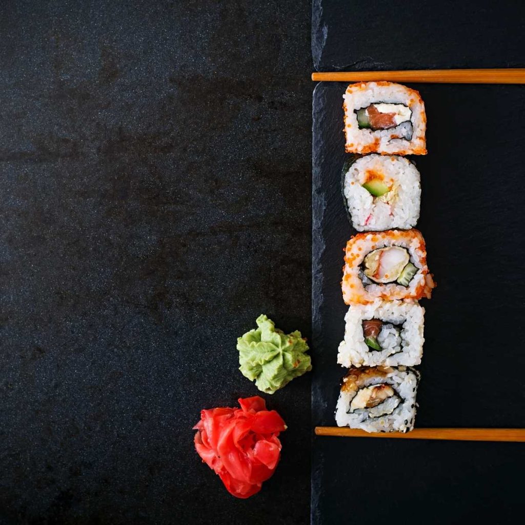 Sushi lined up beautifully on a rustic backdrop for food photography