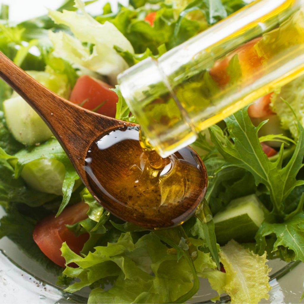 Extra virgin olive oil gets drizzled into a vegetable salad.