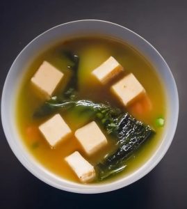 A keto-friendly miso soup made with tofu, vegetables, and greens.