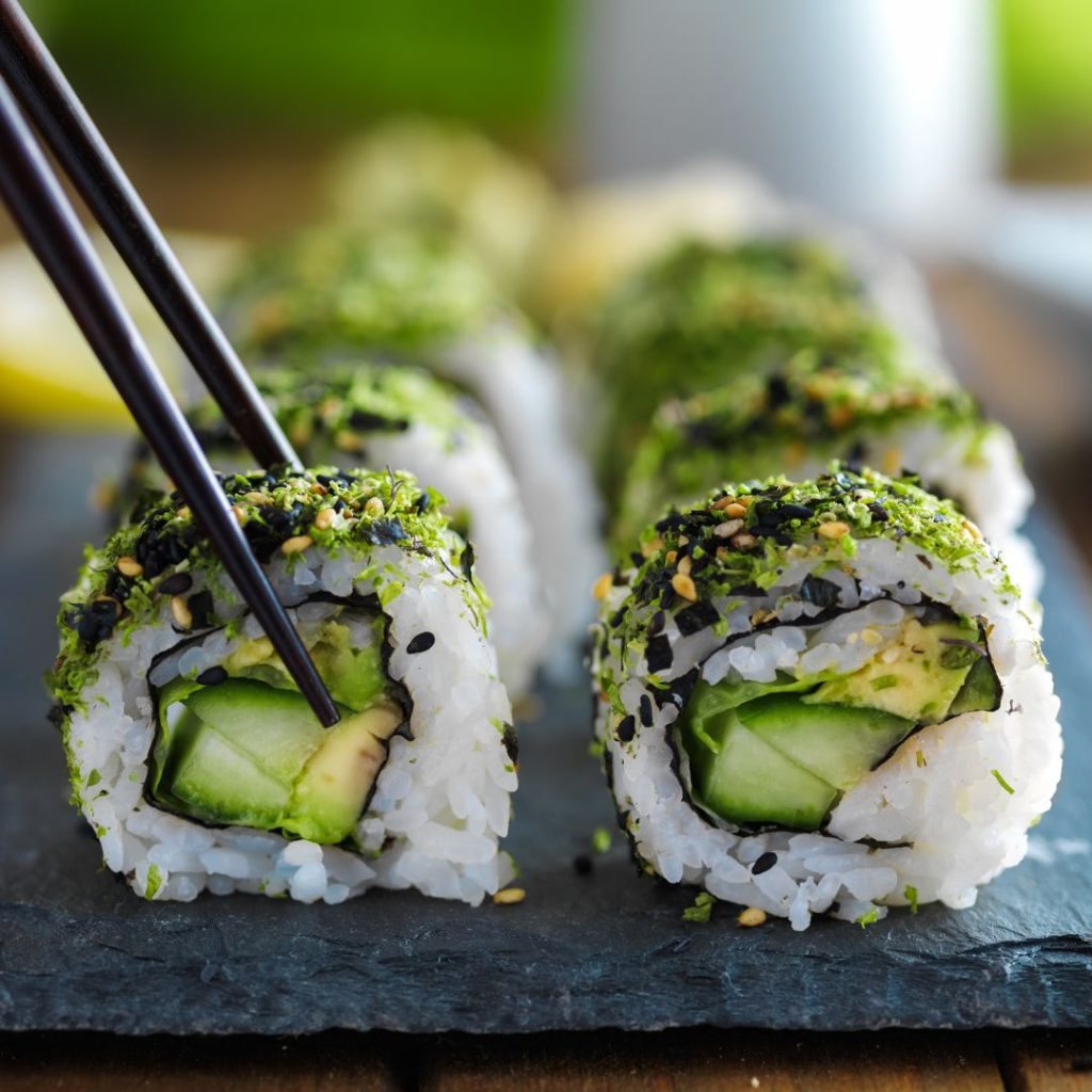 Multiple Avocado sushi rolls lie on the table.