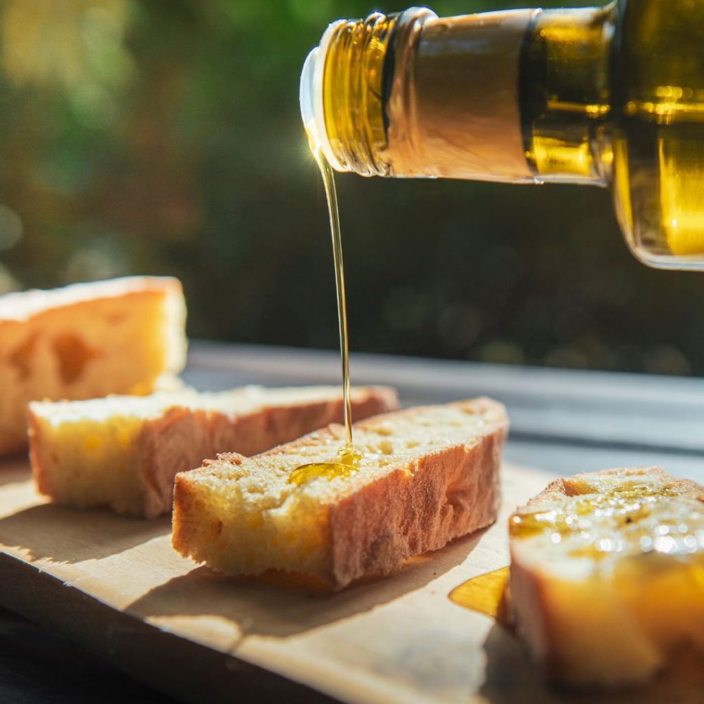 Olive oil gets poured into the bread.