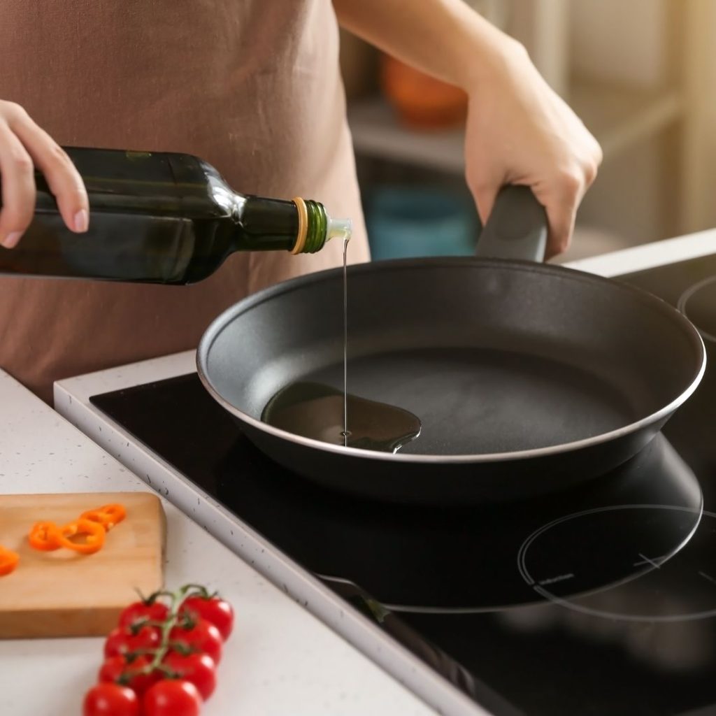 Olive oil gets poured into the pan.