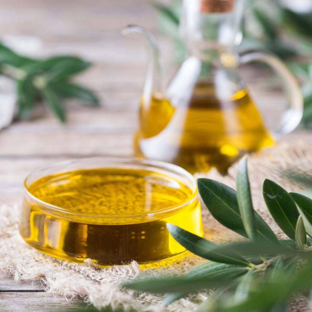 Two containers of extra virgin olive oil sits on the table