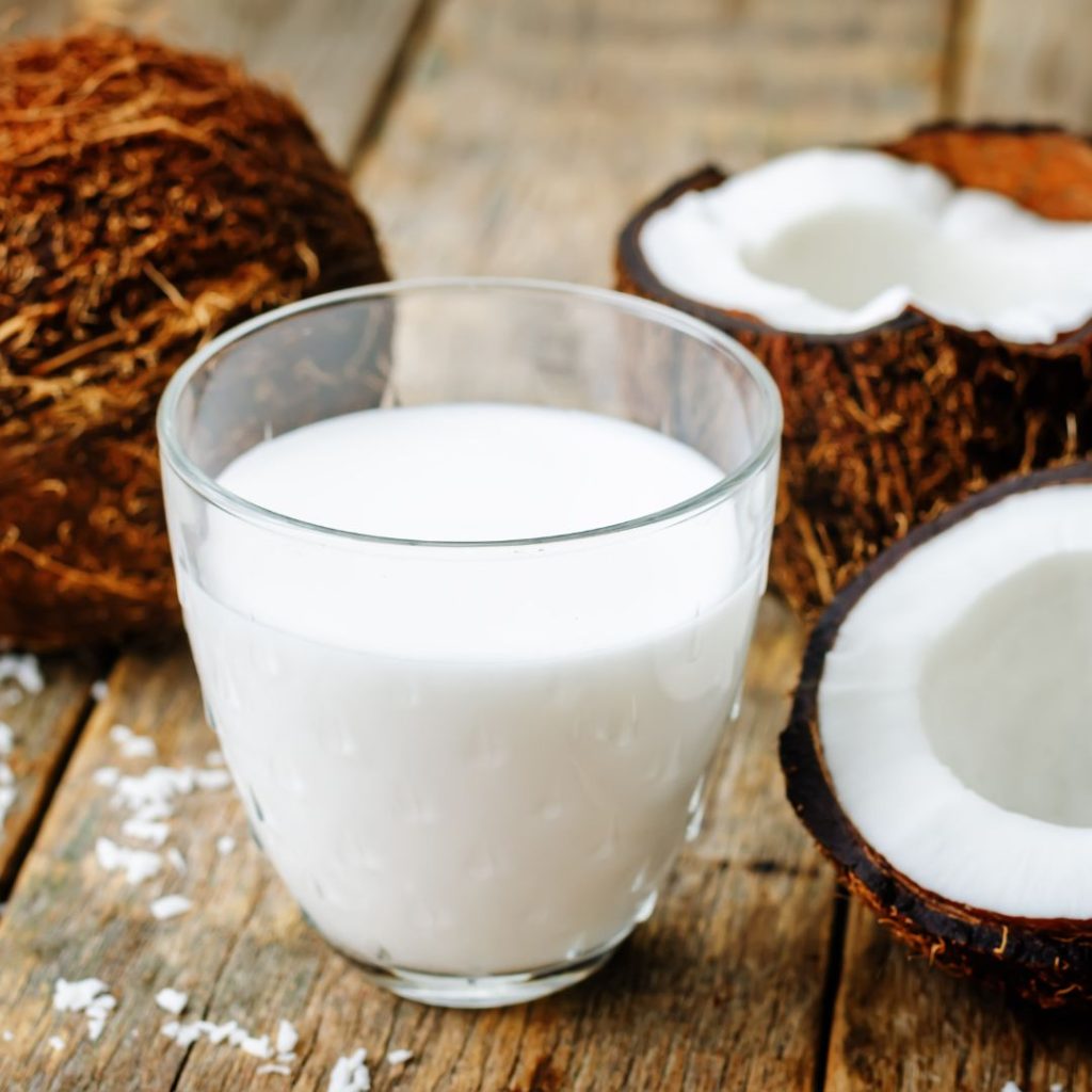 coconut milk in a glass with coconut fruit