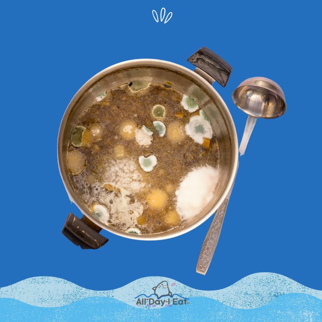 A pot of miso soup with a spoon in it on a blue background.