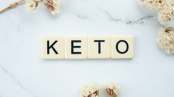 A keto-friendly word "keto" written on a marble surface.