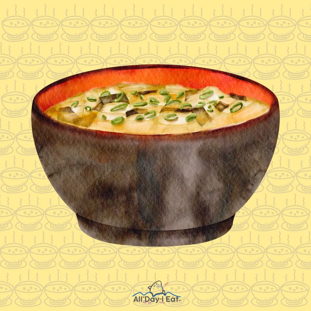 A yellow bowl of miso soup on a background.