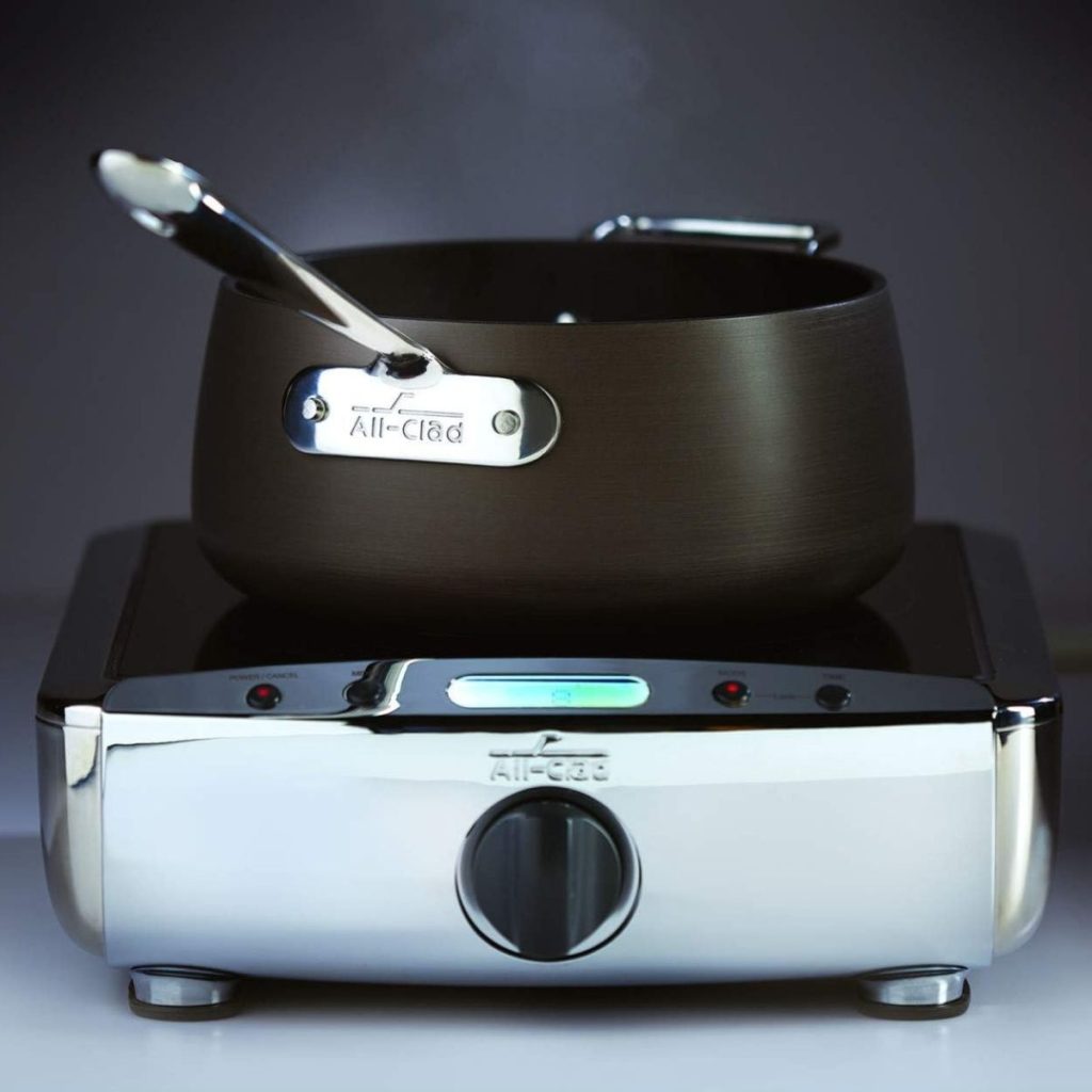 An All-Clad Hard Anodized pan is placed on top of an All-Clad branded stove. (Photo courtesy of Amazon/All-Clad Hard Anodized Review)