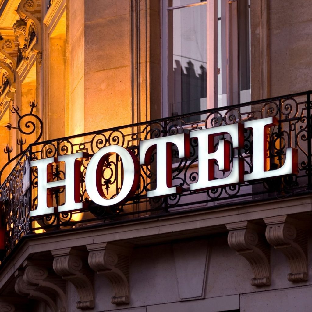 A large signage that says "Hotel" is displayed in front of an establishment.