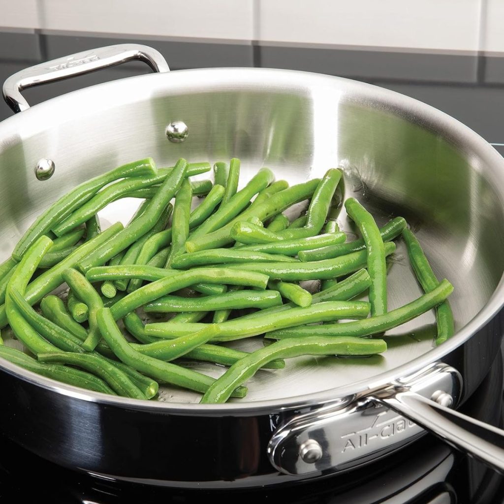 An All-Clad D3 Pan is used to cook vegetables.