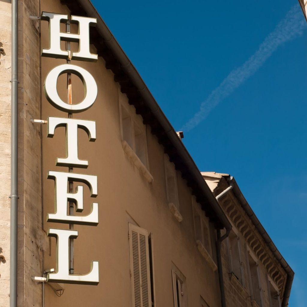 A photo shows the exterior of a hotel on a sunny day.