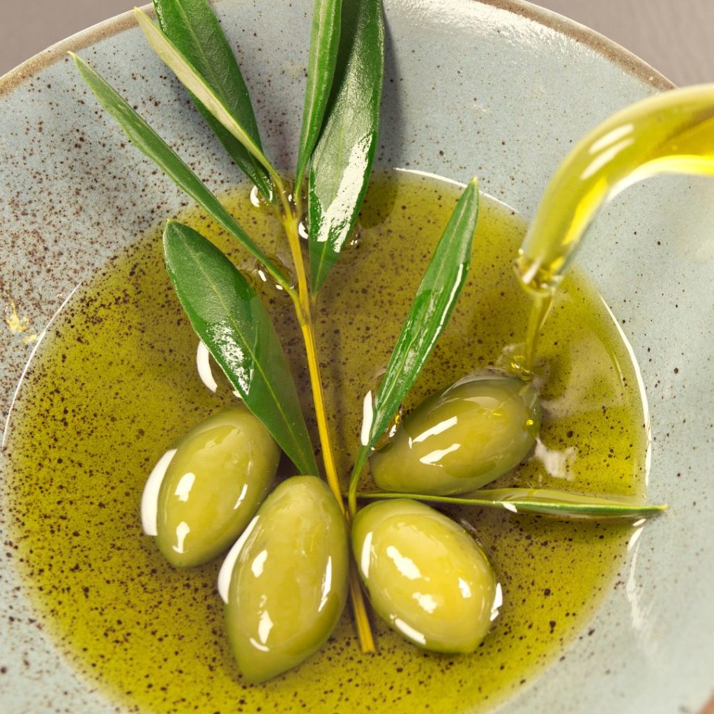 A small bowl filled with extra virgin olive oil was garnished with a sprinkle of pepper.